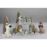 A collection of seven Szeiler porcelain basset hounds and bloodhounds, tallest 20cm, and a Wade