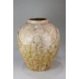 A large baluster vase, the pink carved stone rim with a rough stone body, 45cm high