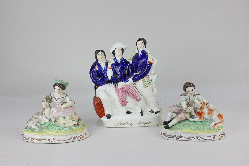 A Staffordshire pottery flat back figure, The Death of Nelson, together with a pair of figures, a