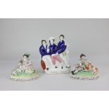 A Staffordshire pottery flat back figure, The Death of Nelson, together with a pair of figures, a