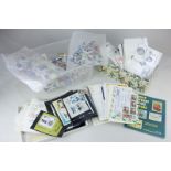 A collection of various first day covers, Churchill commemorative stamps and loose world stamps,