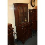 A mahogany secretaire bookcase with dentil carved cornice and two shelves enclosed by two panel