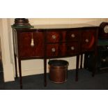 An Edwardian inlaid mahogany break-front sideboard with shaped top, two drawers flanked by two
