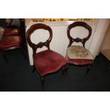 A pair of Victorian balloon back dining chairs with pierced scroll bar back, with differently