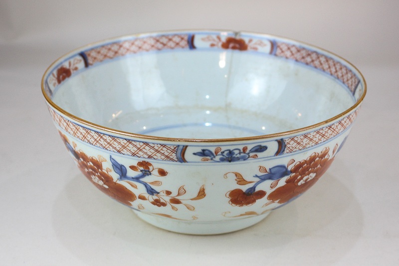 A Chinese porcelain bowl decorated with blossom and flowers in Imari palette (a/f - hairline), 23cm