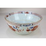A Chinese porcelain bowl decorated with blossom and flowers in Imari palette (a/f - hairline), 23cm