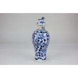 A Chinese porcelain baluster vase and cover decorated in blue and white with dragons amongst flowers