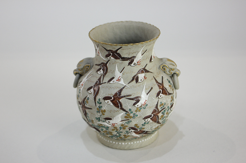 A small Japanese urn shaped vase, the body decorated with bird of prey in a flock of flying birds