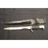 Edge Weapons: World War II German bayonet in scabbard with frog fastening.