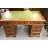 20th cent. Yew twin pedestal desk, 9 drawers, green leather skiver.
