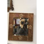 Early 20th cent. Arts and crafts beaten copper wall bevel edged mirrors with stylised fleur de