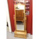 20th cent. Pine cheval mirror held on 2 turned columns on a solid base with a single drawer.