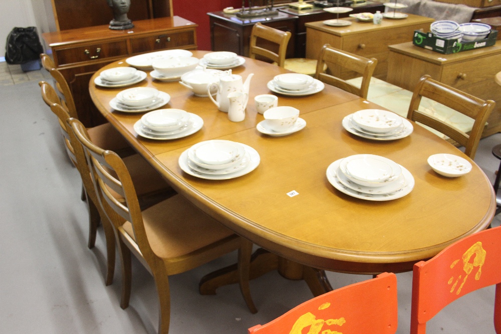 20th cent. Hardwood extending table on twin pedestals with 6 matching chairs. 70ins. x 41ins.