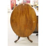 Victorian mahogany loo table of oval form on single support with four well-formed splayed