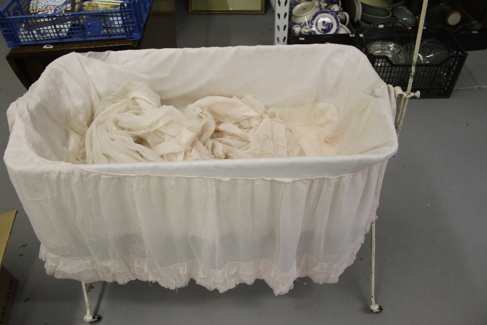 Edwardian iron framed collapsible baby crib with original Organdie drapes.