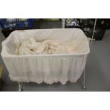 Edwardian iron framed collapsible baby crib with original Organdie drapes.