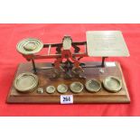 20th cent. Oak and brass Post Office scales with full compliment of weights. 12½ins.