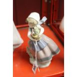 20th cent. Ceramics: Lladro girl walking with a flower pot.