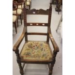 20th cent. Gentleman's oak hall chair with acanthus decoration to the elbow.