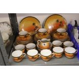 20th cent. Ceramics: Japanese 12 place setting tea service, decorated with a design of a desert at