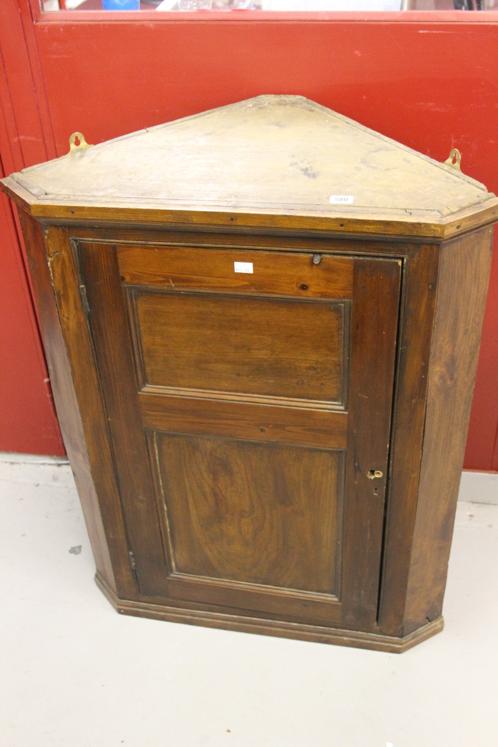 19th cent. Oak wall mounted corner cupboard with shaped shelving.