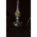 20th cent. Oil Lamp, cast iron base with a clear glass reservoir.
