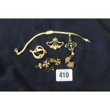 Gold: Cleft shaped brooch, studded with red stones, stamped 18ct. 2.5grams. A 9ct. Liberty bat