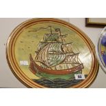 20th cent. Terracotta slipware wall plate depicting a sailing ship 12ins x 12ins.