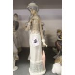 20th cent. Ceramics: Lladro girl with basket a/f. Cascades lady with a parasol and an unmarked