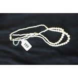 Jewellery: Double strand cultured peal necklace with white metal clasp set with a single pearl.