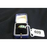 Gold Jewellery: Emerald and diamond boat shaped ring marked 750 and tests 18ct. gold.