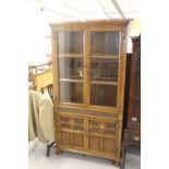 20th cent. Honey oak bookcase cupboard in a Jacobean style 36ins x 71ins x 12ins.