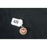 19th cent. Jewellery: A Victorian gold. foil-backed quartz & bead round glazed locket back pendant.
