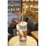 20th cent. Ceramics: Majolica umbrella stand decorated with flowers containing two walkingsticks.