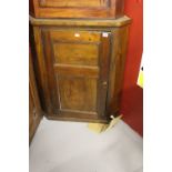 19th cent. Oak wall mounted corner cupboard with shaped shelving.