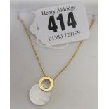 French Hallmarked Gold: 18ct. Gold ring shaped pendant with mother of pearl disc on chain, with