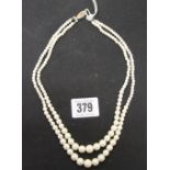 Jewellery: Double strand cultured peal necklace with white metal clasp set with a single pearl.