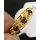 Hallmarked Gold: 18ct. Boat shaped ring with 3 rubies & 2 diamonds set in 3.3grams inclusive.