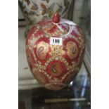 20th cent. Oriental Red ground vase with cover, enamel painted floral decoration. 11ins.