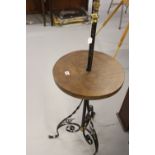 20th cent. Wrought iron standing lamp with treen shelf.