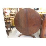 Early 19th cent. Mahogany tilt top table; the base having ball & claw feet. 53ins. diameter.