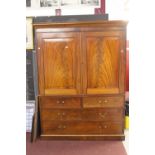 20th cent. Mahogany linen press. The top has twin doors opening to reveal the hanging rail & 4