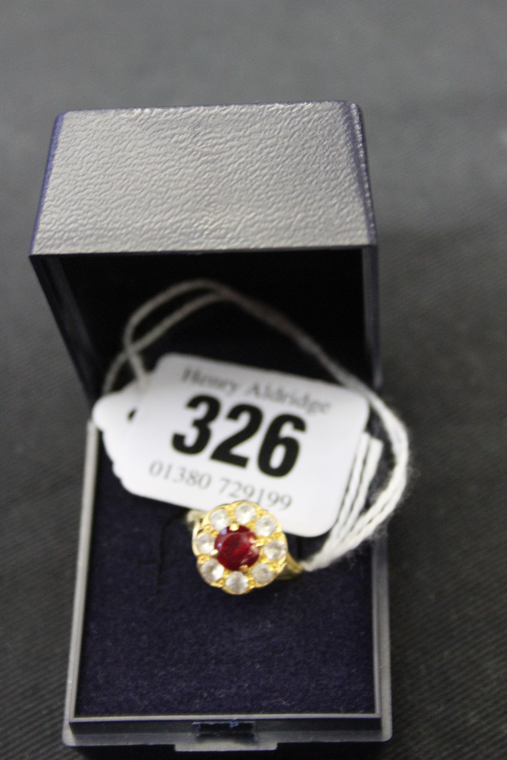 Jewellery: Yellow metal treated ruby ring with white sapphires, test 18ct.