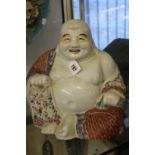 Early 20th cent. Chinese famille Rose ceramic figure of Budai-Hoshang seated holding his treasure,