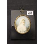 Early 19th cent. Oval portrait painted miniature of a young woman on ivory. 3½ins.