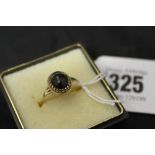 Jewellery: Yellow metal black onyx cabochon ring, tests 9ct. 1.6g inclusive.
