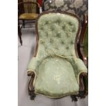 20th cent. Mahogany upholstered button back nursing chair, floral carved frieze to back, ornate