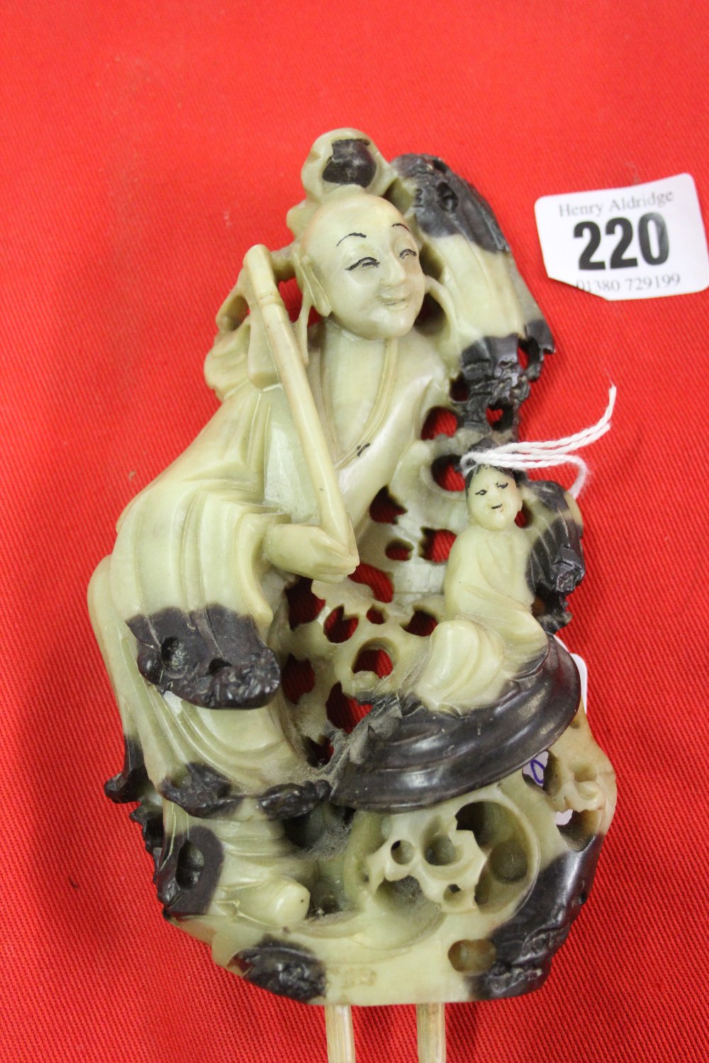 Oriental Figures: A soapstone Japanese carved figure of deity and child.