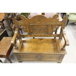 Late 19th cent. Oak settle carved back and front with compartment under seat.