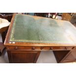 19th cent. Mahogany library/partners desk with period gilt tooled skiver raised on two pedestals,